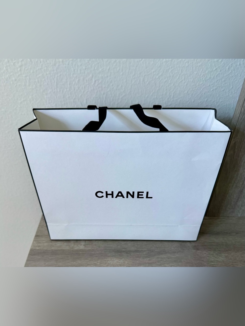 White and Black Logo Retail Gift Bag. Elegant shopping bag with bold logo.